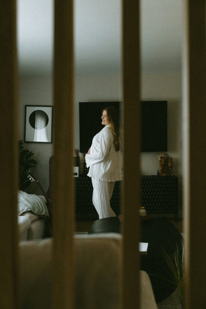 wife posed while camera shoots through some banisters