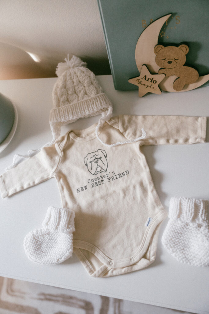 a baby onesie that says "Chester's new best friend"