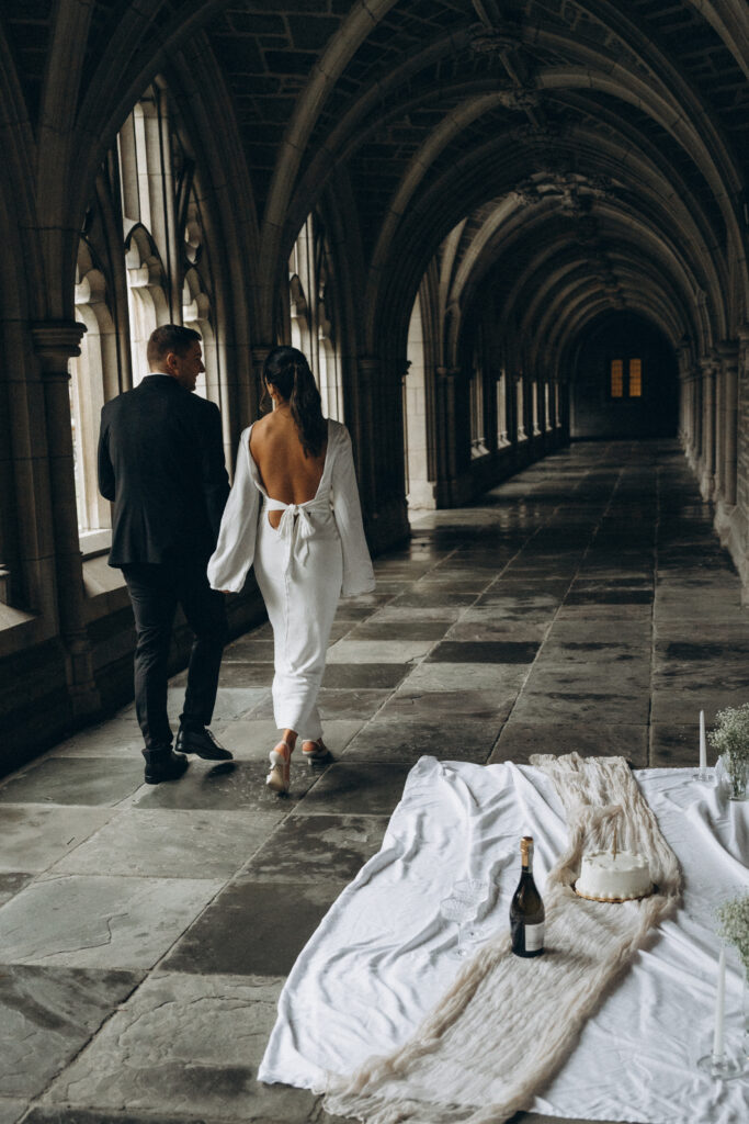 husband and wife walking together holding hands while facing away from the camera.