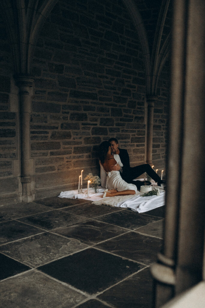 husband and wife kissing while all candles are lit