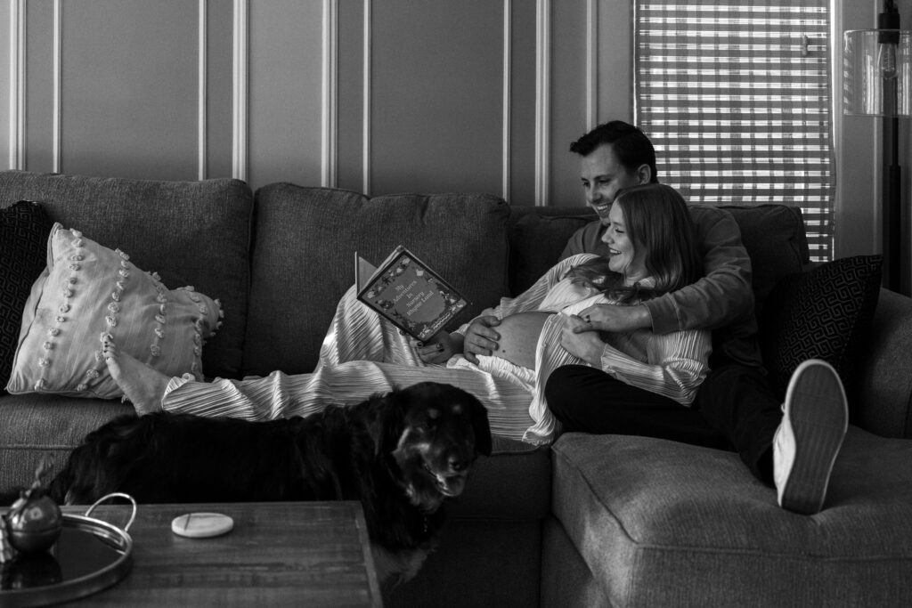 husband and wife reading a children's book together 