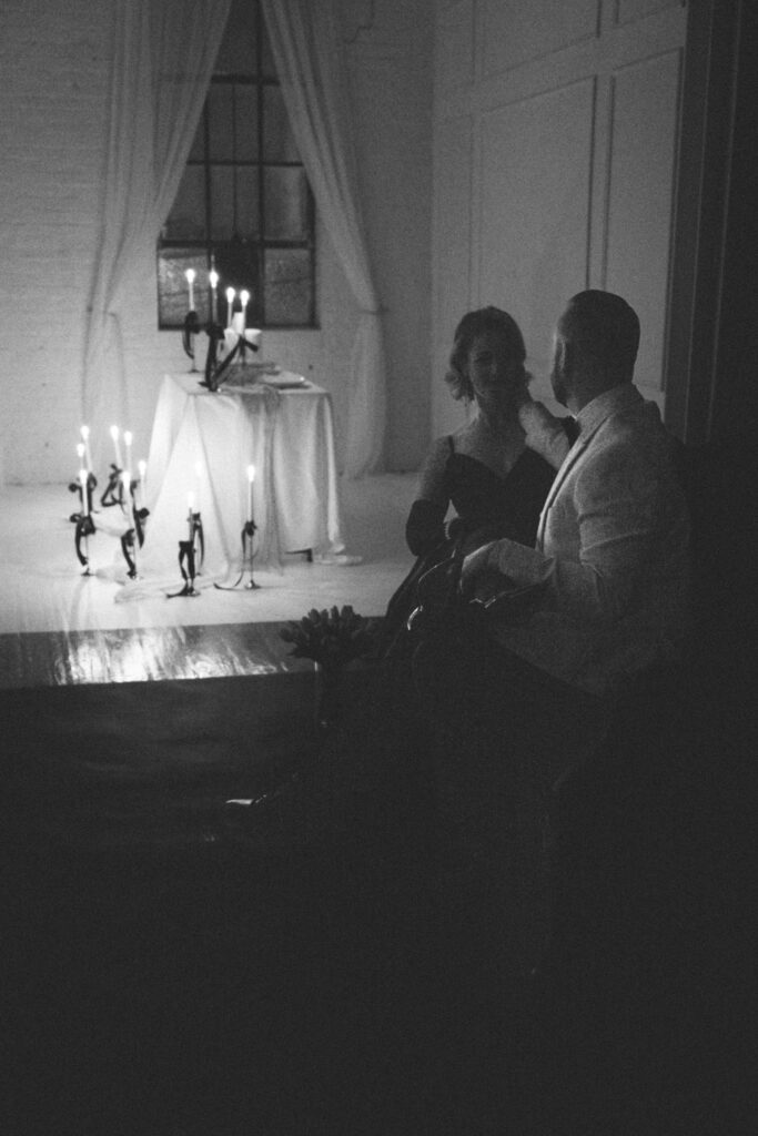 husband and wife gazing at each other while sitting on the couch