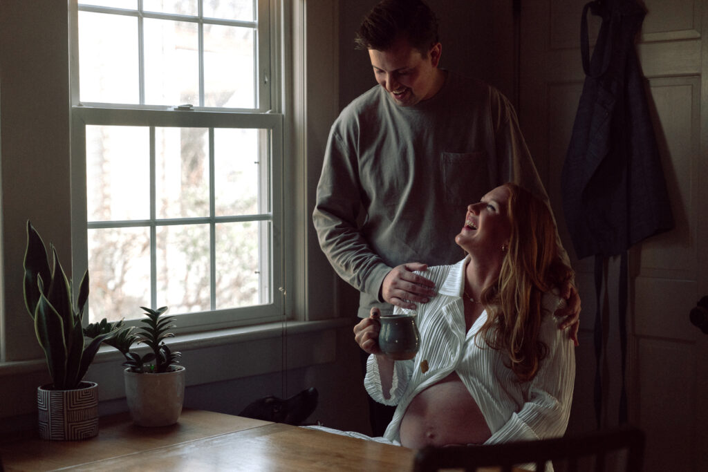 husband and wife laughing in the kitchen