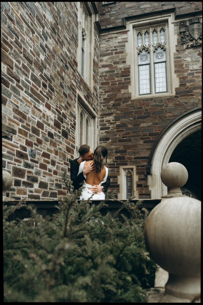 husband kissing wife on her neck outside