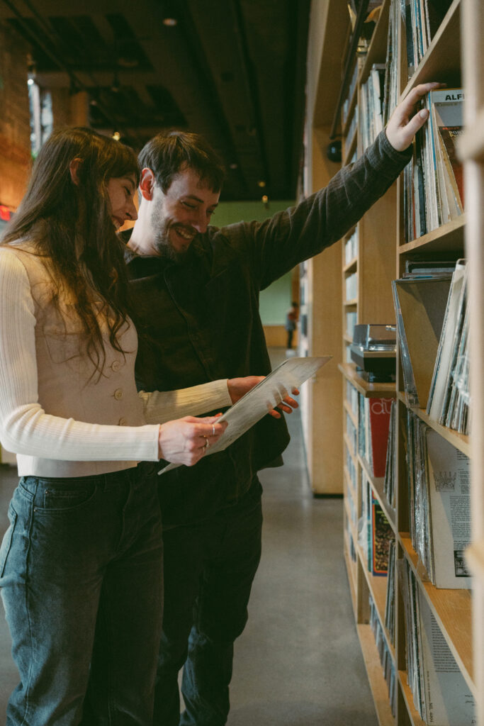 couple smiling while talking about vintage records