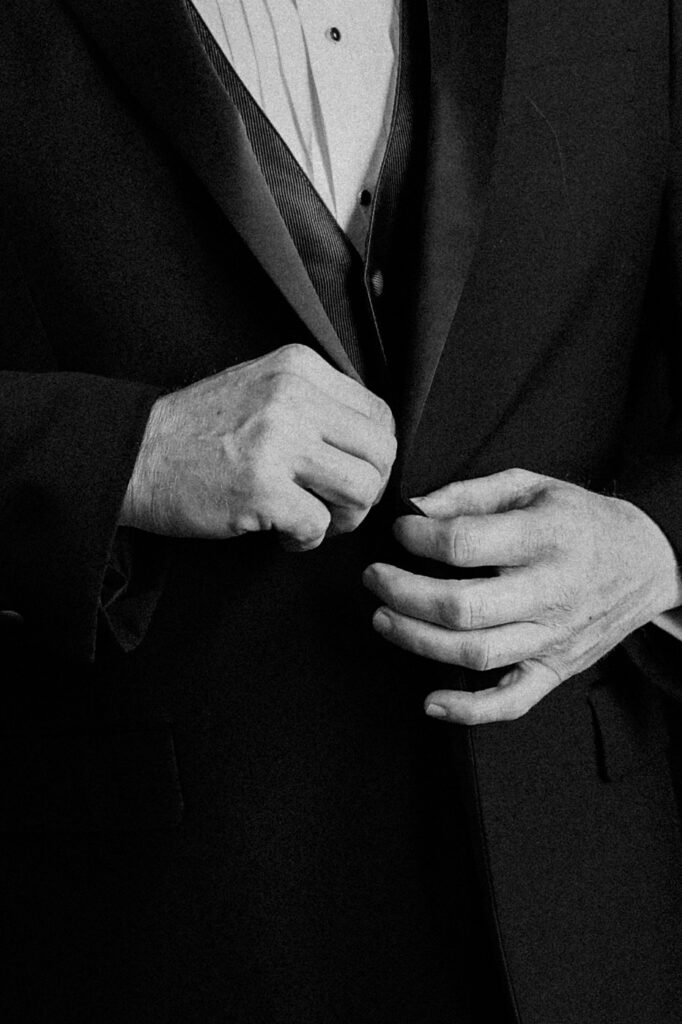 up close groomsmen getting dressed