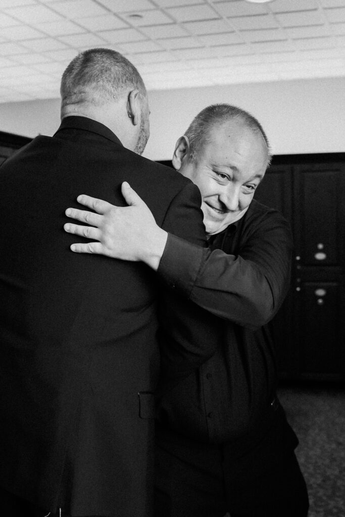 groomsmen hugging