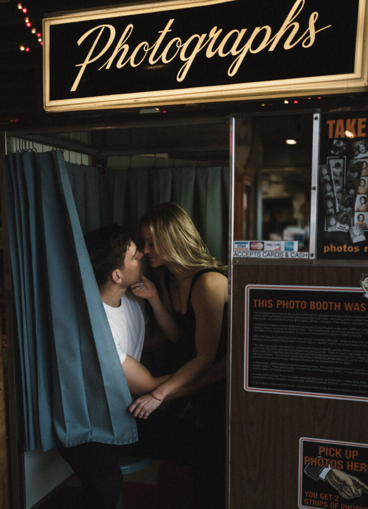 couple in photobooth while the woman goes in for a kiss