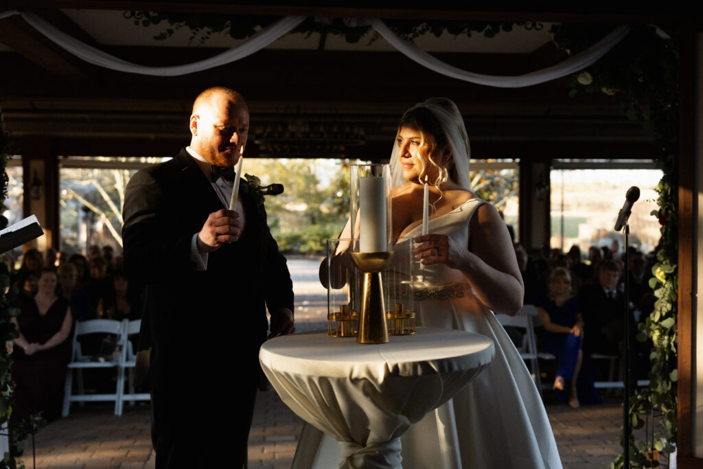 husband and wife lighting a unity candle