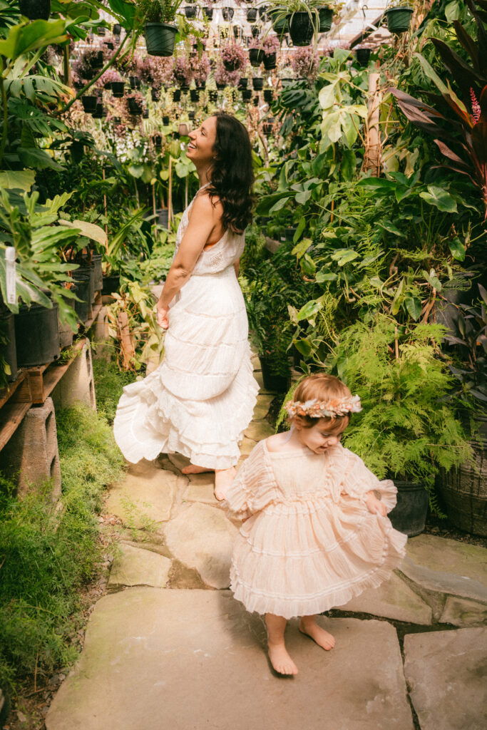 mother and daughter dancing in the garden