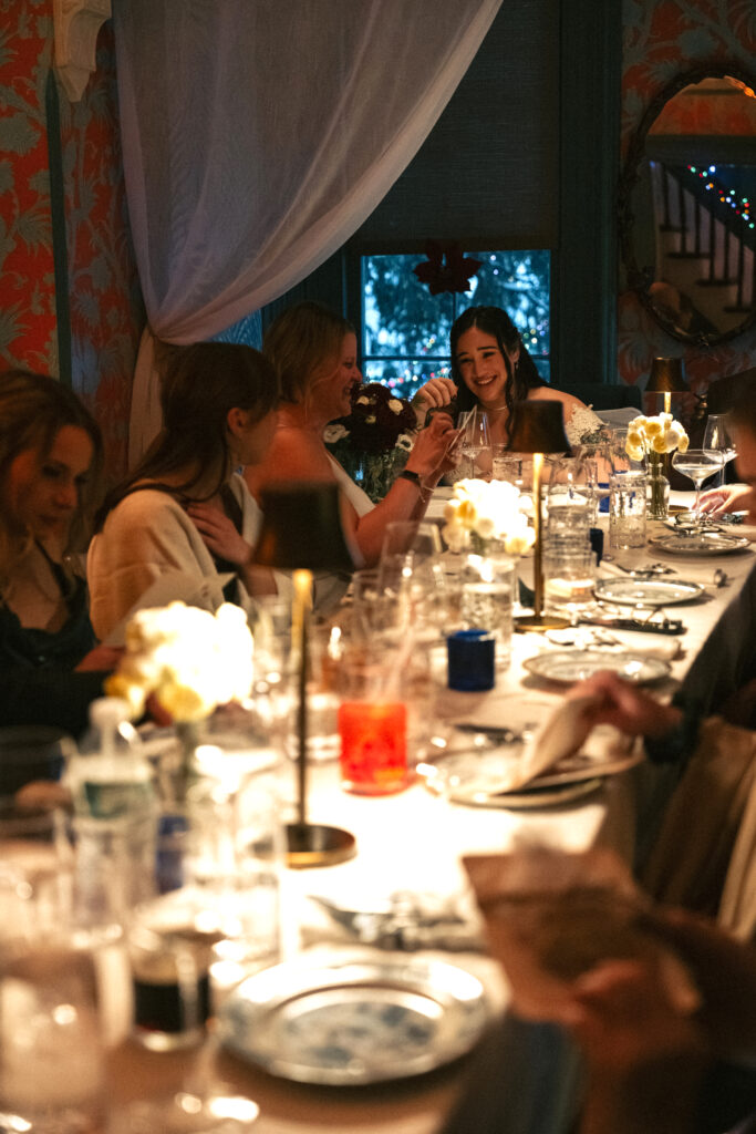 bride laughing at the dinner table during their intimate wedding reception