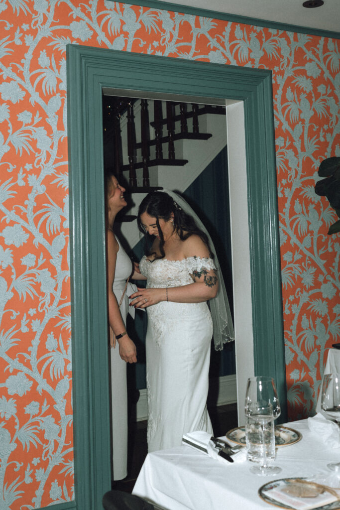 bridesmaid and bride laughing together