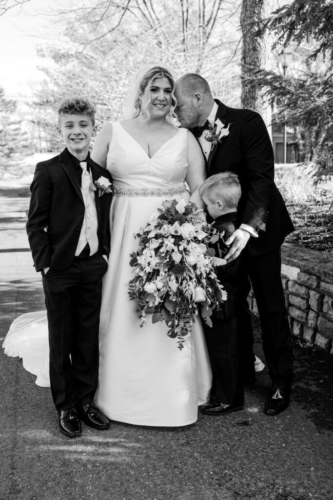 family portrait of bride, groom and 2 sons