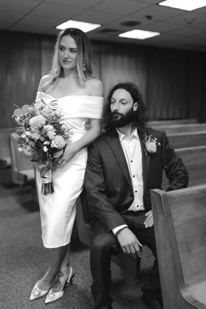 couple posing at the courthouse during their elopement