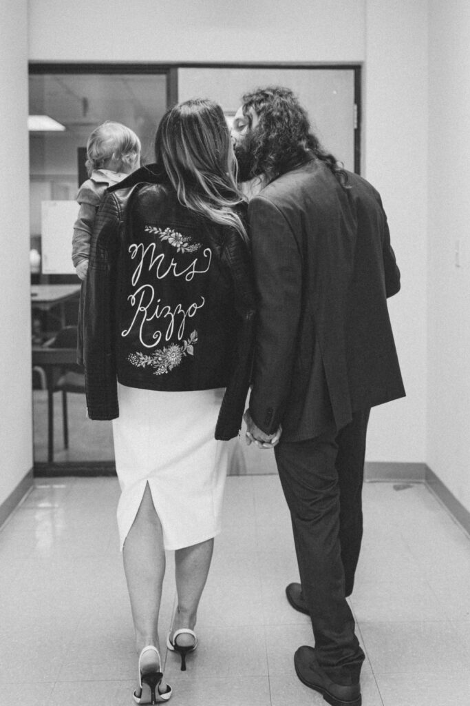 couple kissing while holding hands